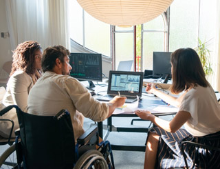 Disabled manager with staff members